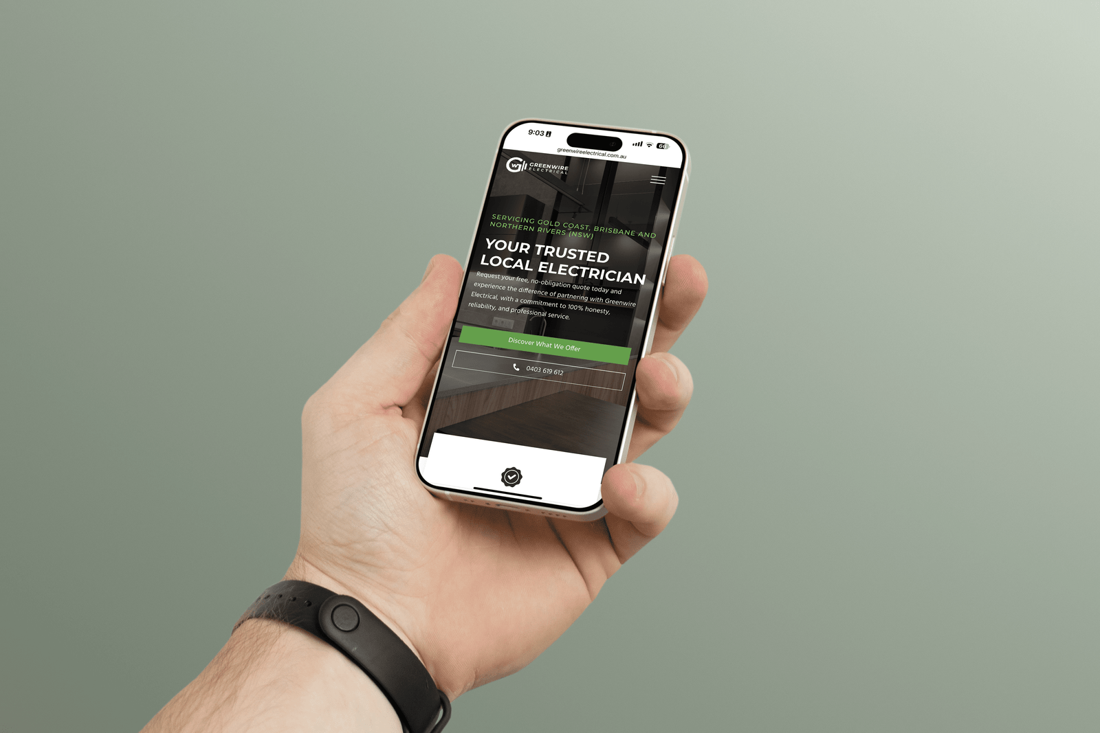 hand holding greenwire electrical website on iphone